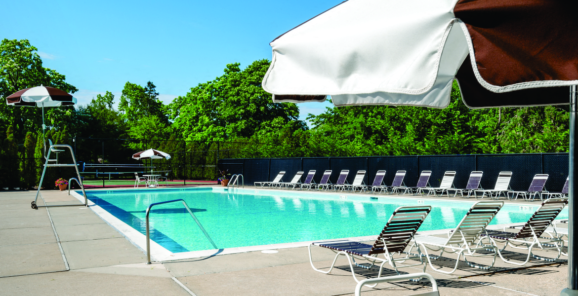 Outdoor Pool with Lounge chairs on the deck at Hillcrest Village, Holbrook, NY, 11741